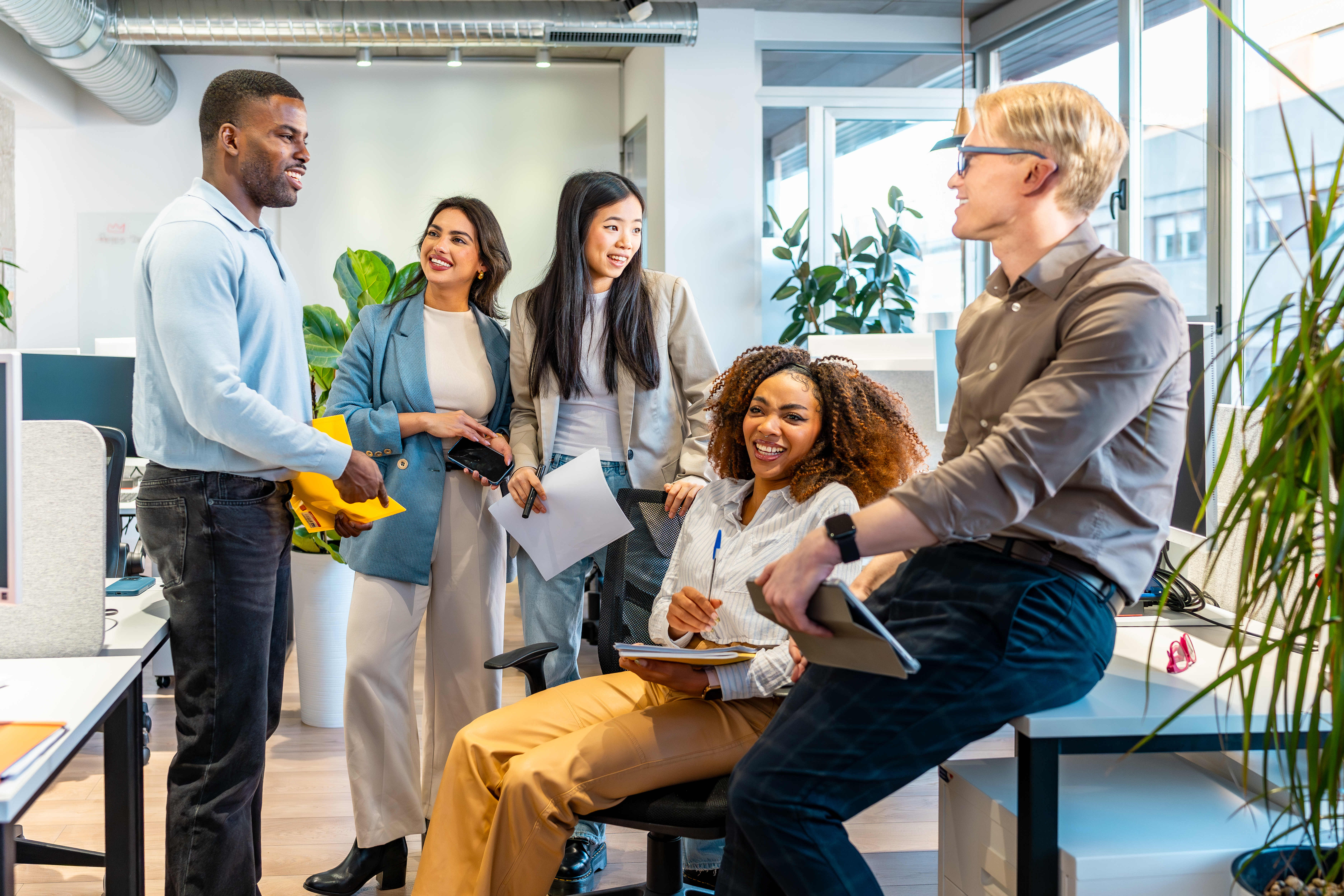 Coworkers exchanging ideas in modern office