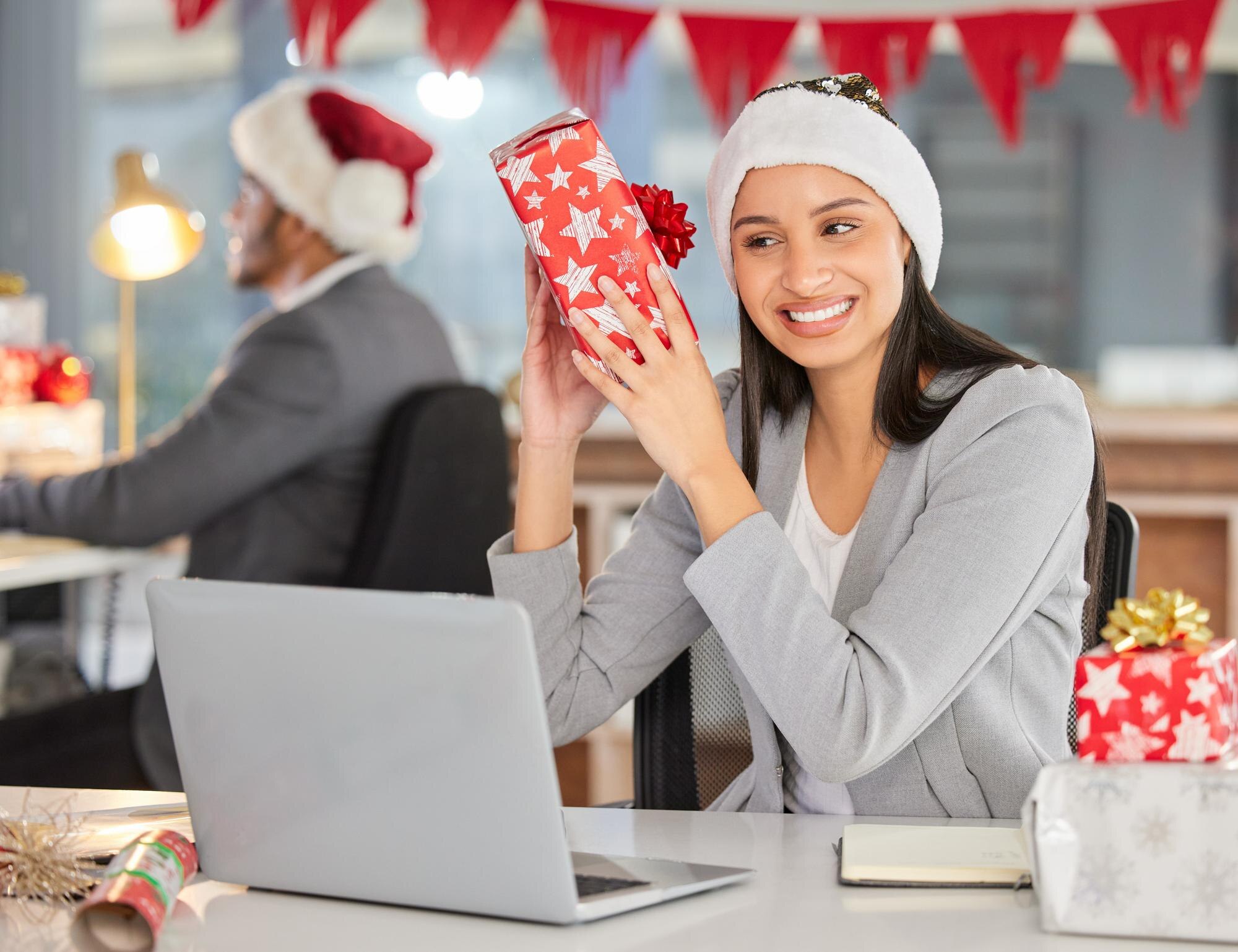 Employee curious and woman with christmas gift won