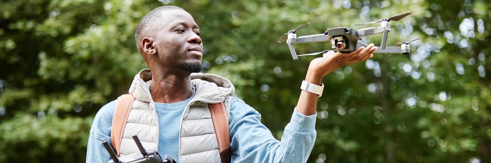 Header image of black man holding drone outdoors