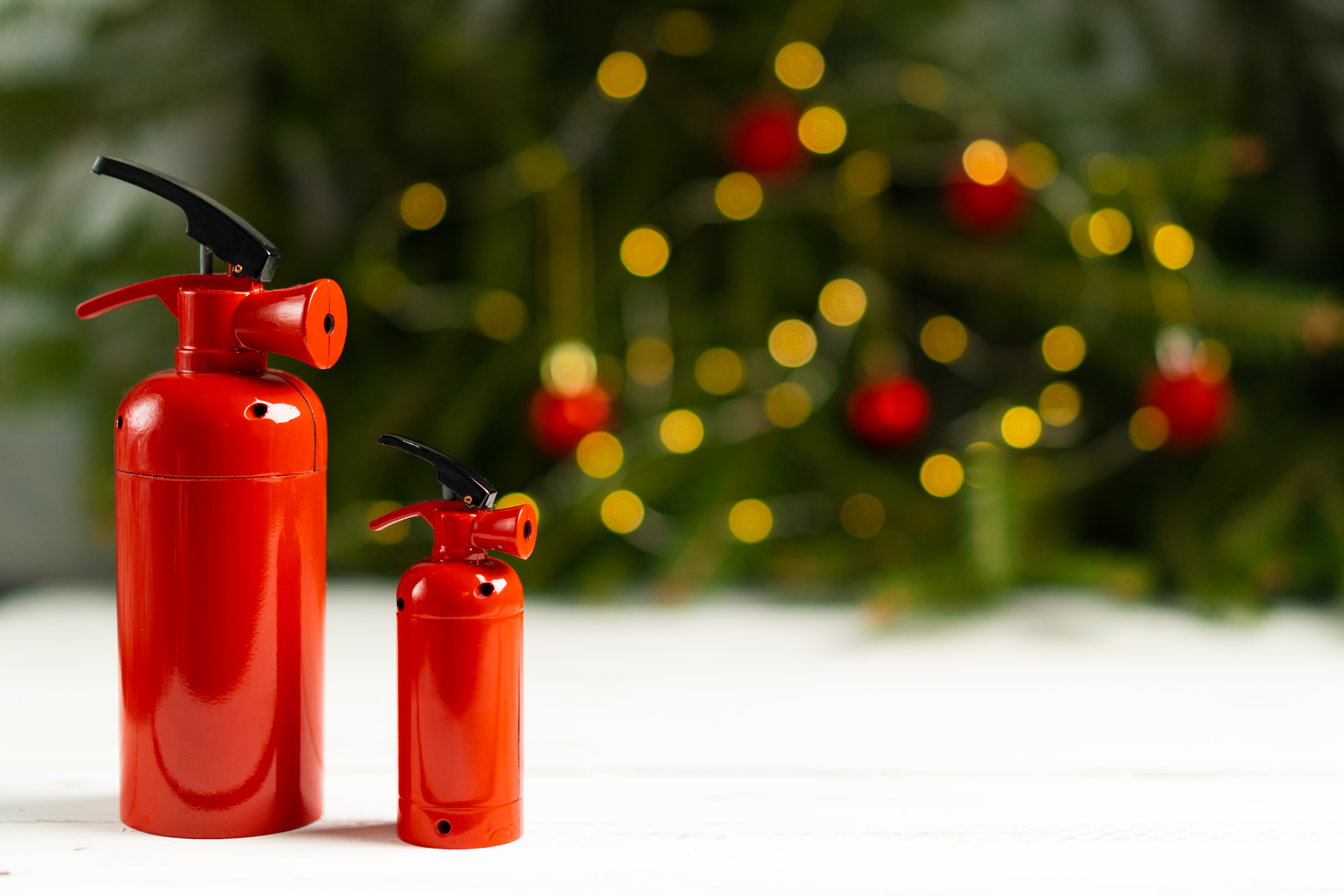 The fire extinguisher stands on a white table aga