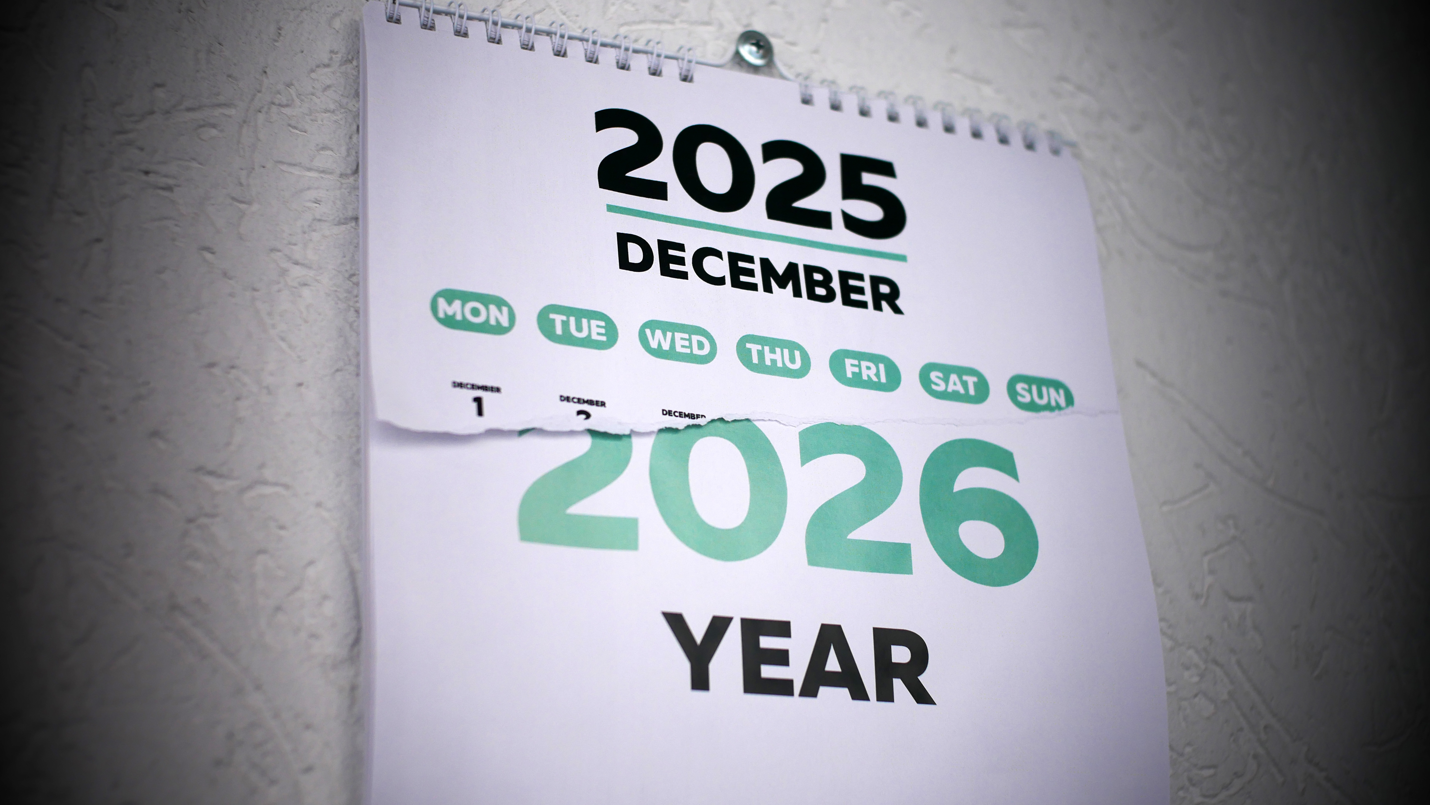 A half torn december page of a wall calendar follo