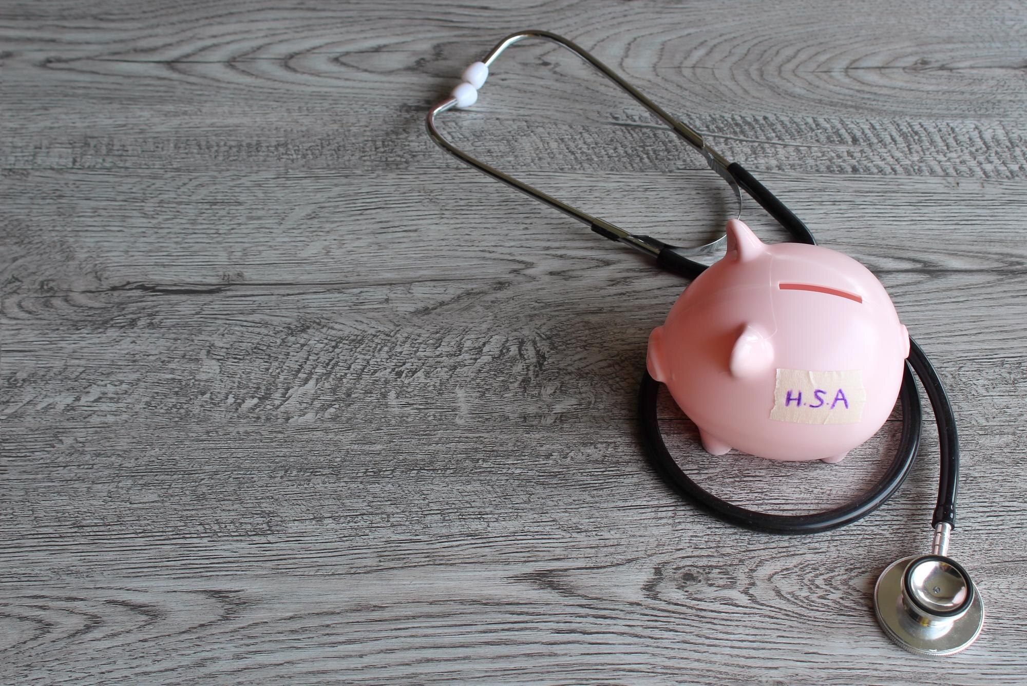 Hsa or health savings account text on piggy bank