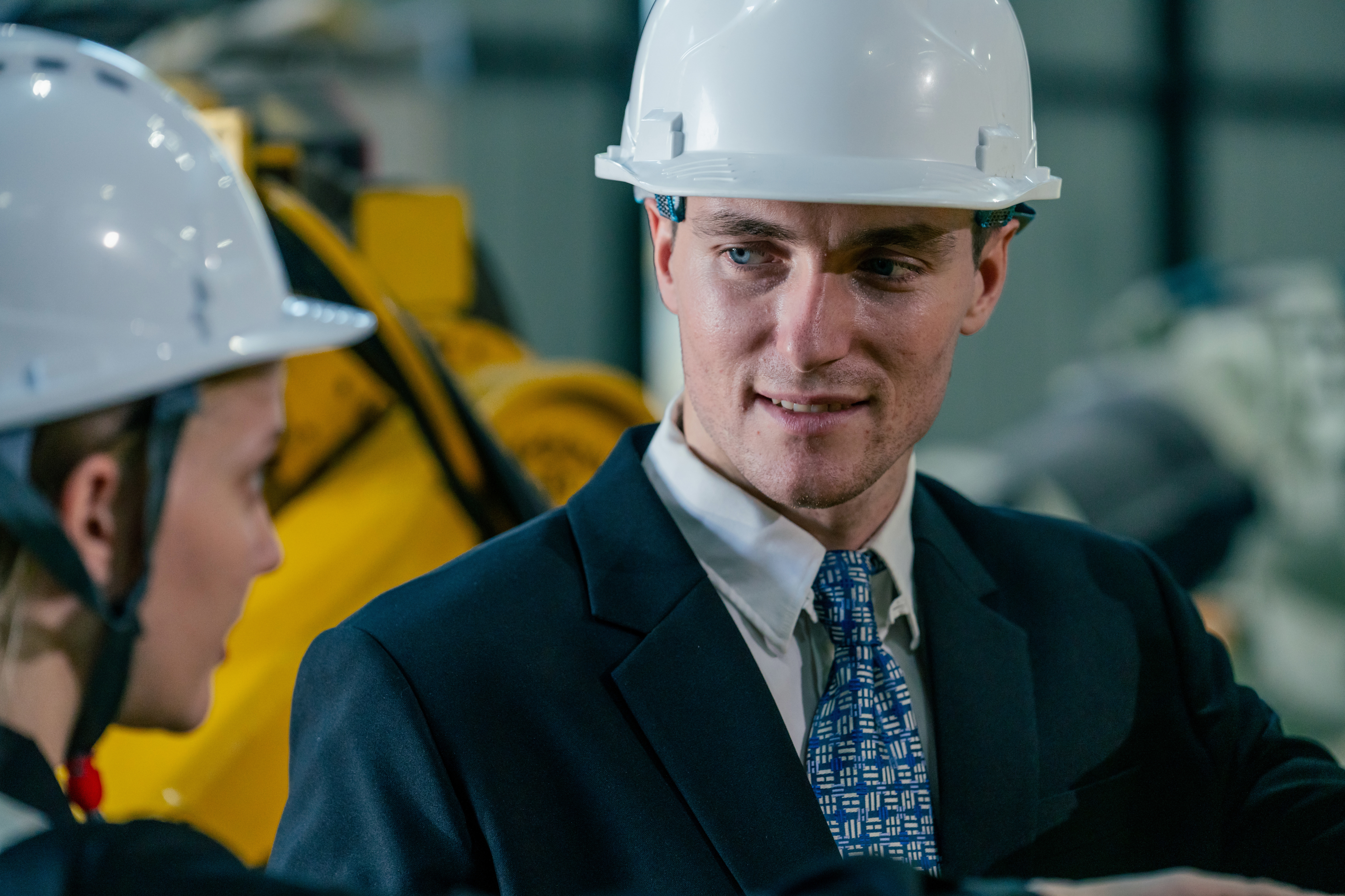 Professionals in safety helmets discuss project