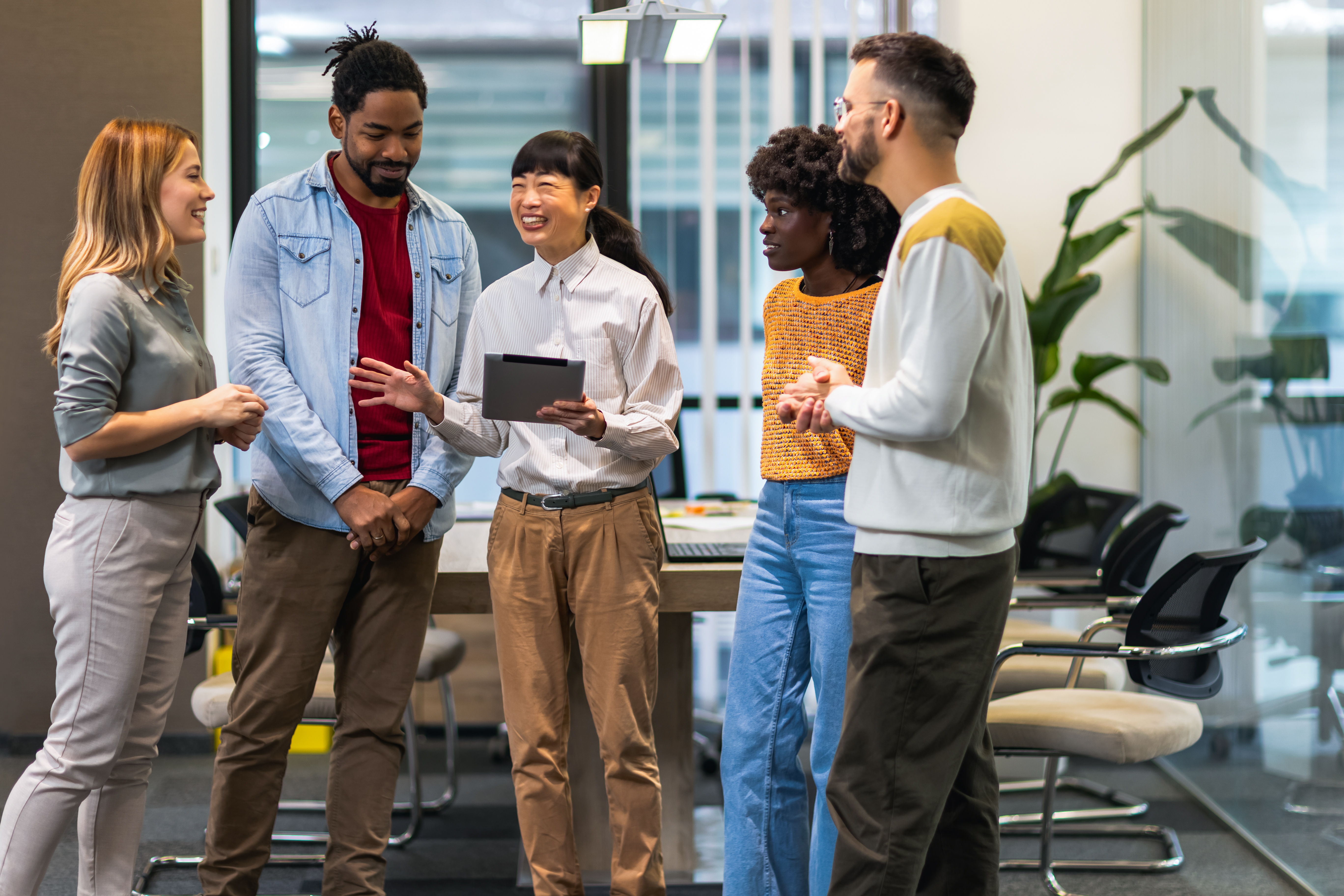 Multiethnic colleagues standing together and talki