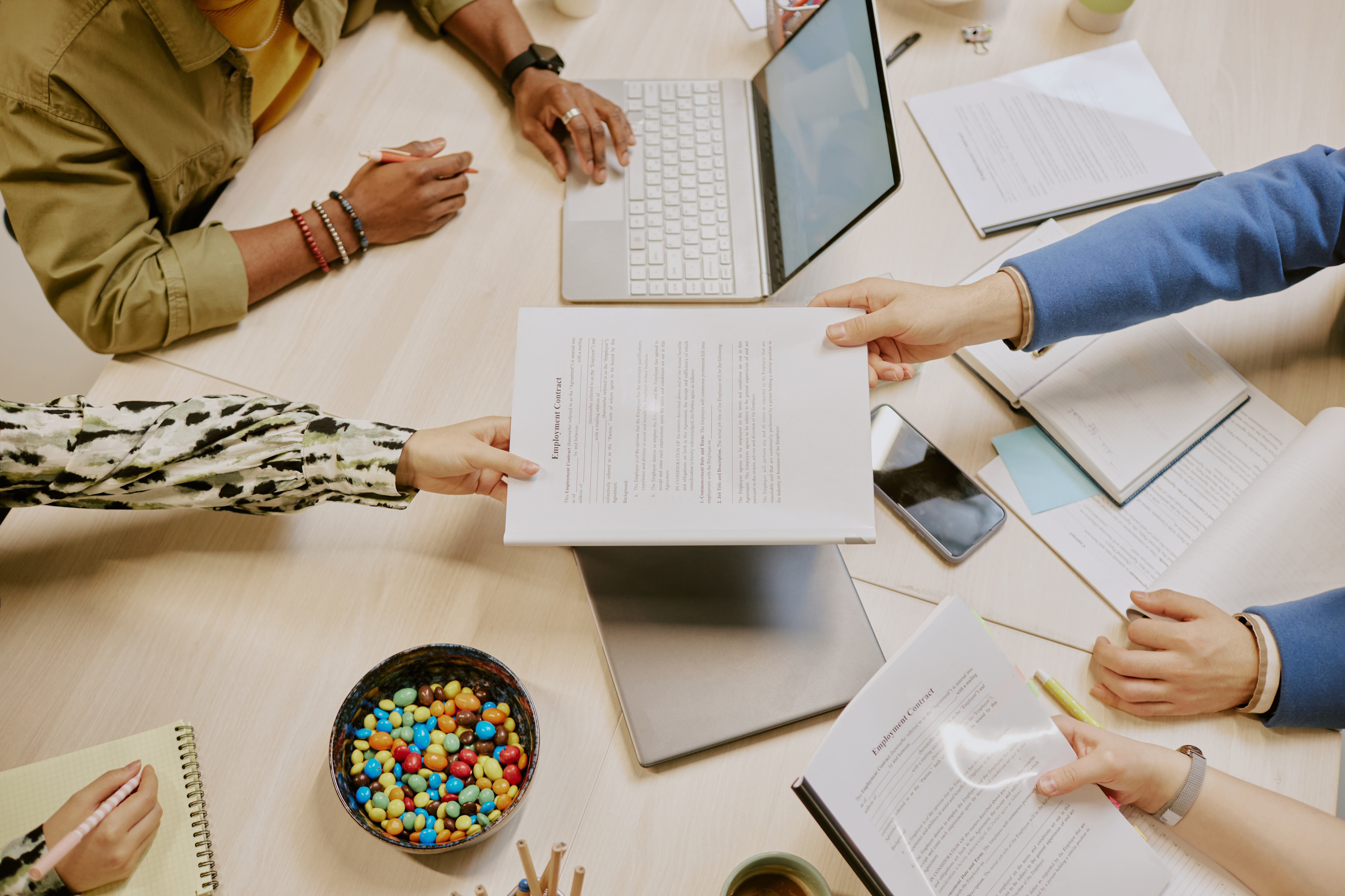 Unrecognizable group of managers making agreement