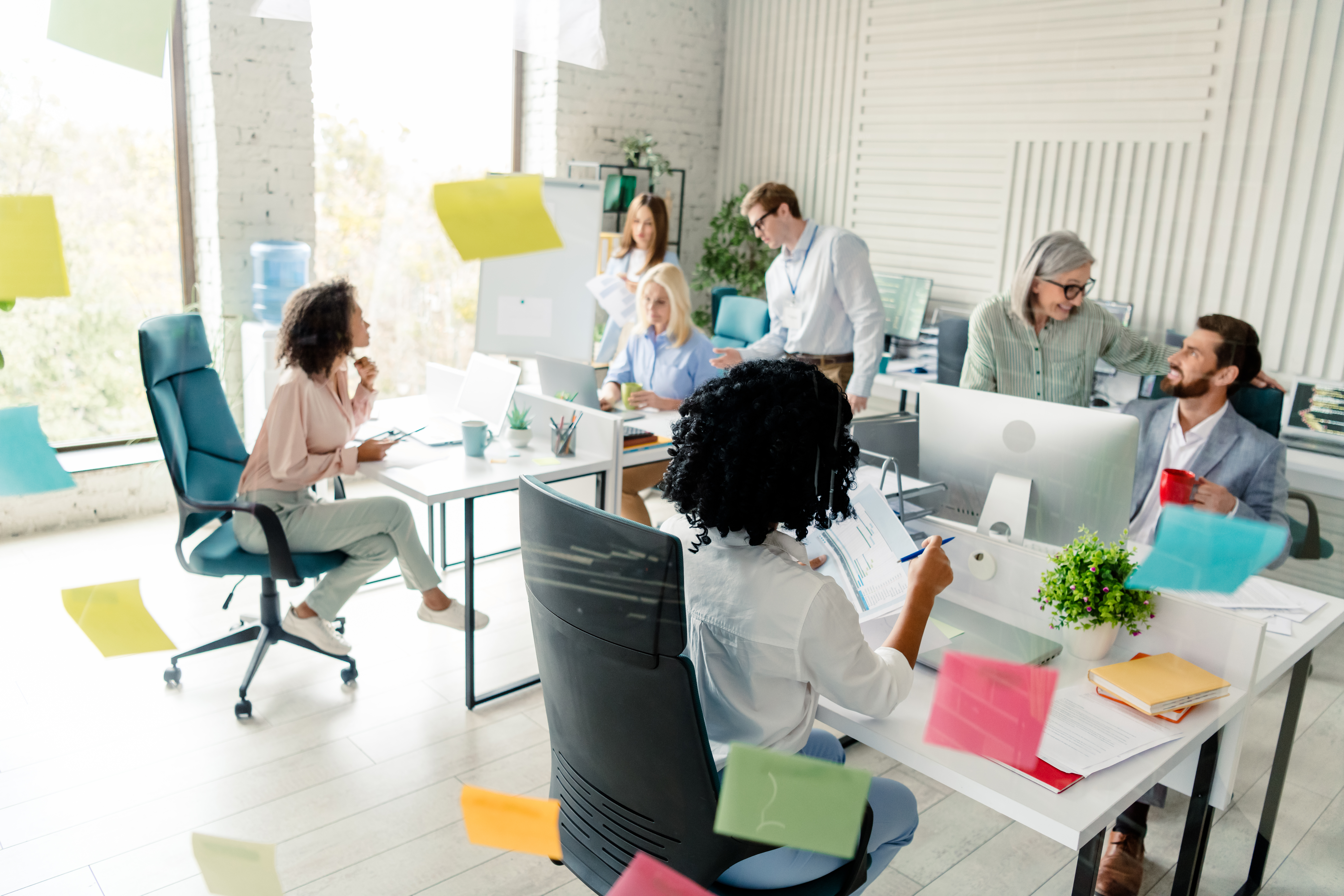 Diverse team collaborating in modern workplace wit