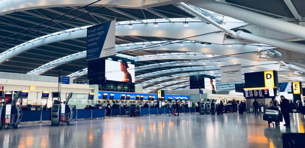 Family at an airport terminal checking travel documents before boarding, symbolizing travel insurance and peace of mind.